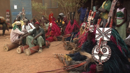 Masks and musicians wait to perform in Boromo
